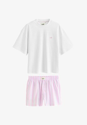 White short-sleeve T-shirt with small pink "self." logo paired with light pink and white striped elastic-waist shorts with button fly.