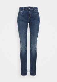 Mörkblå denimjeans med slim fit, med fem fickor, dragkedja och subtil blekning på låren. Midjehöjd konstruktionsdesign.