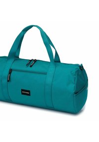 Borsa a tracolla teal realizzata in tessuto resistente, dotata di manici doppi, una tasca frontale con zip e una forma rotonda per un trasporto pratico.