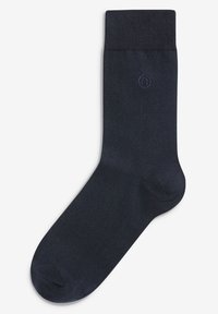 Calcetines de color azul marino hechos de un material suave y elástico, con un puño acanalado y un pequeño logotipo bordado en púrpura. Diseño simple y sólido.