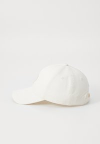 White baseball cap featuring a curved visor, six-panel design, and subtle stitching. Includes an adjustable strap at the back.