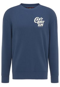 Blå crewneck-tröja i bomullsblandat material. Har en vit tryckt text "CAN'T BUST 'EM" på vänster bröst. Ribbad mudd och nederkant.
