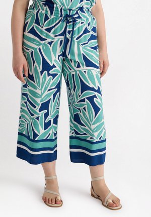 Wijde broek in blauw met grote groene bladerenpatronen. Gemaakt van lichtgewicht stof, met een trekkoord taille en een gestreepte zoom.