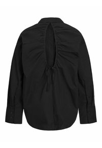 Maglietta nera con un design arricciato nella parte posteriore, schiena aperta con chiusura a cordoncino, maniche lunghe e polsini abbottonati. Tessuto dalla texture liscia.