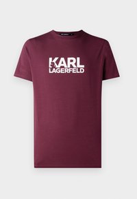 Burgundské tričko s krátkým rukávem a kulatým výstřihem s bílým logem "KARL LAGERFELD" a siluetou na hrudi.