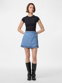 Črn kratek rokav fitted top, v kombinaciji z svetlo modrim denim zavitom krilu, ki ima zavezan pas in raztrgane robove, dopolnjen s črnimi škornji do kolen.