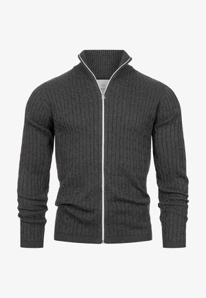 Grauer Rippstrick-Cardigan mit hohem Kragen und weißem Reißverschluss, ausgestattet mit langen Ärmeln und einer taillierten Silhouette. Hergestellt aus einem weichen Material.