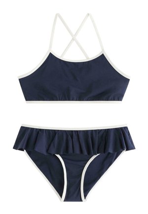Mørkeblå to-delt badedragt med hvide kanter, der har en top med krydsende ryg og bikiniunderdele med flæser.