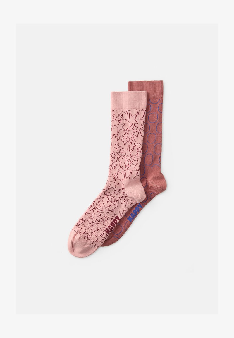 Calcetines rosas con un patrón de estrellas en la izquierda y un color sólido con acentos circulares en la derecha, ambos con puños acanalados y una marca de contraste.