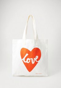 White tote bag with long handles, featuring a large red heart graphic and the word "love" inside the heart in white script.