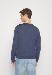Pulover tricotat de culoare bleumarin, cu mâneci lungi și decolteu rotund. Caracteristici includ un material texturat și tivuri și manșete cu dungi. Imaginea prezintă partea din spate.