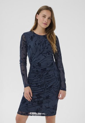 Navy long-sleeve dress featuring a textured floral pattern, ruched detailing along the side, and a fitted silhouette.