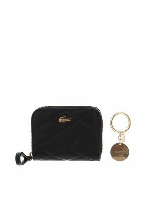 Black quilted zip wallet with gold crocodile logo and a gold keyring with round tag and small crocodile charm.