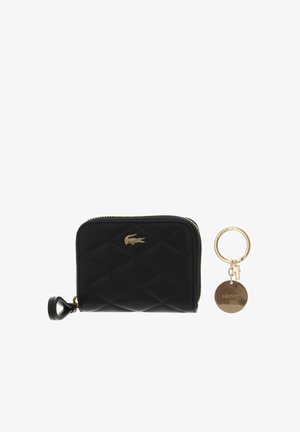 Black quilted zip wallet with gold crocodile logo and a gold keyring with round tag and small crocodile charm.