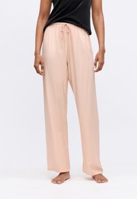 Lichtroze, loszittende broek met elastische tailleband van gladde, zachte stof. Voorzien van een trekkoord voor aanpassing.