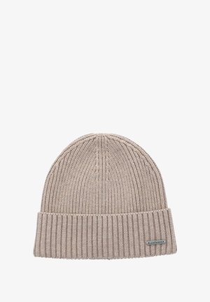 Kardigan w jasnym beżu, z prążkowanym mankietem i gładką górą. Posiada małą metalową metkę z logo z boku.