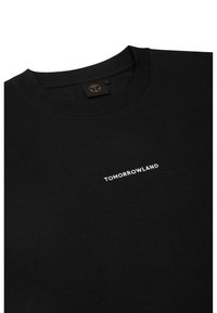 Zwarte crewneck sweatshirt van katoen, met een witte "TOMORROWLAND" logo op de voorkant. Soepele textuur met een klassieke pasvorm.