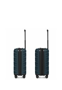 Deux valises rigides bleu sarcelle foncé avec quatre roues et des poignées télescopiques noires étendues, montrées debout côte à côte.