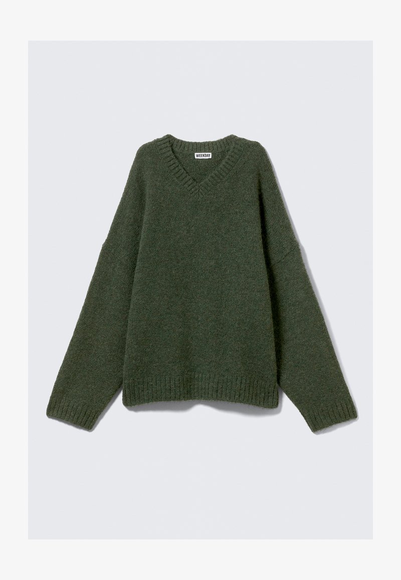 Grønn strikket genser med V-hals, oversized passform og ribbestrikkede mansjetter. Myk tekstur og minimalistisk design for komfort og allsidighet.