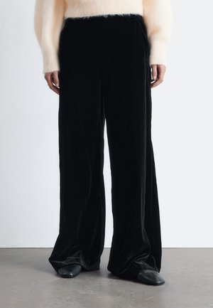 WIDE - Trousers - black
