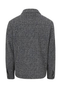 Wollen jas, donkergrijs met een subtiel ruitpatroon, gestructureerde kraag en lange mouwen met knopmanchetten. Geweven stof.