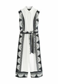 Ärmlös jumpsuit i vitt bomull med svarta blommönster och detaljer. Har en krage, bälte i midjan och vida ben med scallop-erade fållar.