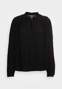 Schwarze Longsleeve-Bluse aus glattem Stoff. Sie hat einen gerafften Kragen, eine Bindeschnur und eine lockere Passform, mit dezenten Falten an den Ärmeln.