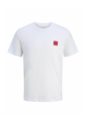 White cotton t-shirt with short sleeves, featuring a small red square patch with black text on the left chest area. Classic crew neck design.