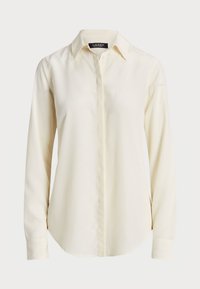 Krämfärgad långärmad skjorta med knappar och spetsig krage, med dold knäppning framtill, skräddarsydd för en smidig passform.