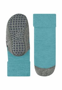 Calze turchesi con suole antiscivolo grigie a pois. Le caratteristiche includono una texture in spugna, polsini a coste e accenti a contrasto sulla base.