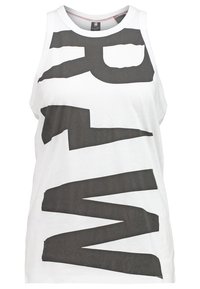 Vit ärmlös tanktop med djärva, abstrakta svarta grafik. Tillverkad av mjukt bomullstyg med rund halsringning och avslappnad passform.