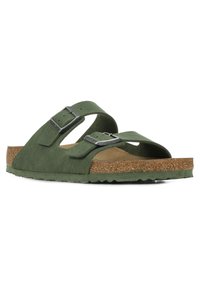 Green sandal with two adjustable straps, made of fabric, featuring a cork footbed and textured rubber outsole for grip.