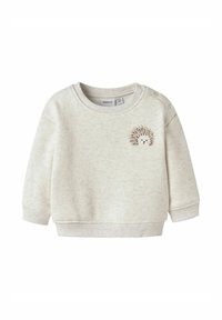 Jasnoszara bluza z miękką fakturą, z haftem jeża z przodu i detalami na zatrzaski na ramieniu.