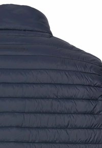 Marineblå pufferjakke med horisontalt quiltet design, glat tekstur og en høj krave. Inkluderer et diskret logo på ryggen.