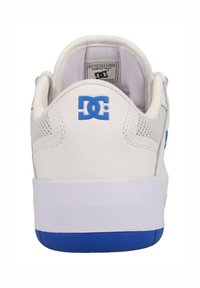 White sneaker with blue accents and mesh sides. Features a textured leather upper, padded collar, and solid rubber sole. DC logo on heel.