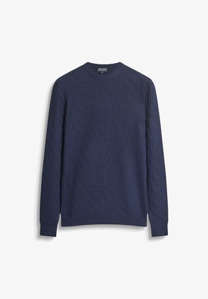 Pull en maille bleu marine à manches longues avec un motif texturé en zigzag et des poignets et un ourlet côtelés.