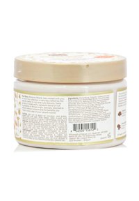 Moisture Miracle hair cream in a cylindrical, white jar with a beige, patterned lid. Contains detailed ingredient and caution information on the side.