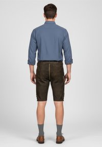 Men’s outfit featuring a blue long-sleeve shirt, dark brown shorts, grey socks, and brown shoes. Shorts have a smooth texture and contrasting stitching.