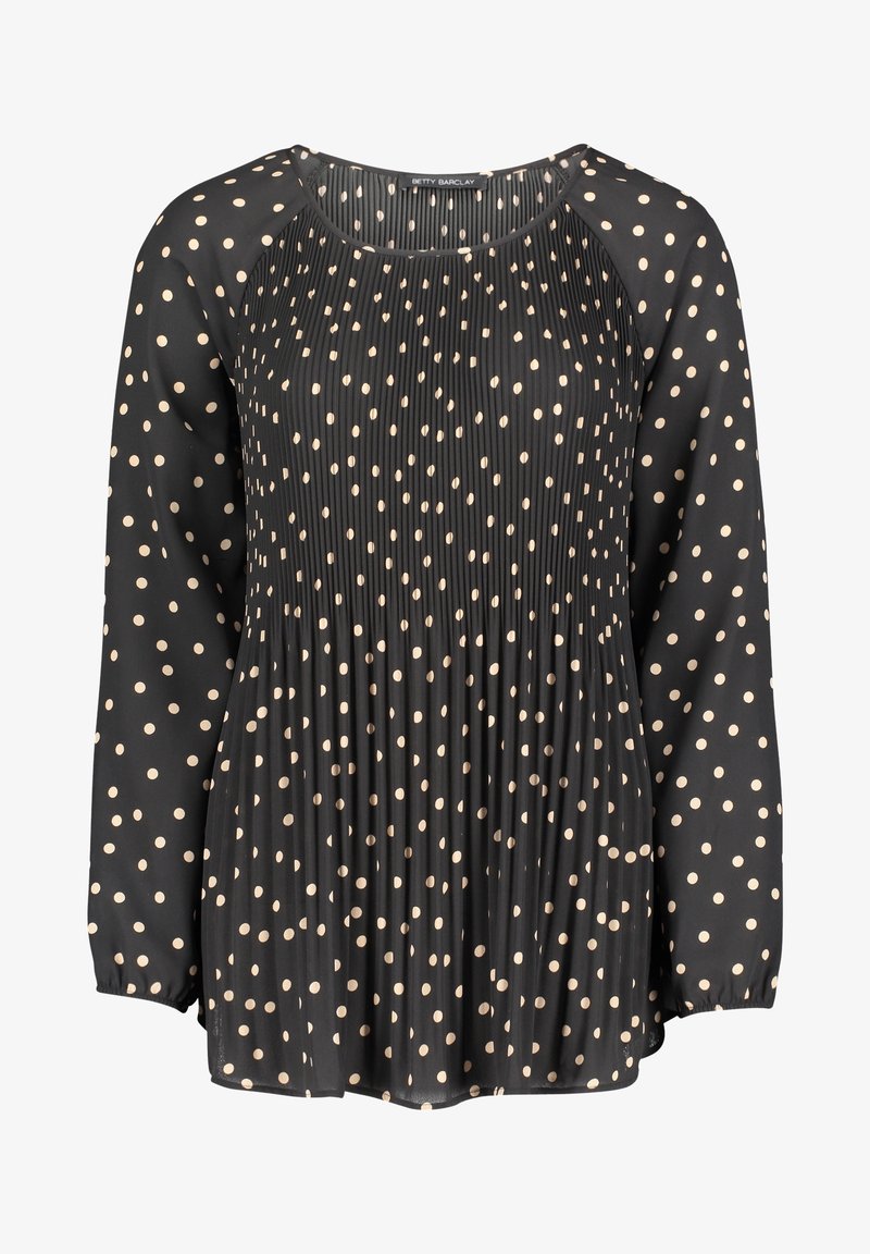 Blouse noire à manches longues avec des pois beiges et un panneau avant plissé, dotée d'un col rond et de poignets élastiques.