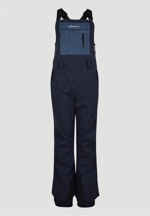 Navy blue vedenet bib haalarit, joissa on rintatasku denimi tekstuurilla, säädettävät hihnat ja joustavat hihnat nilkassa.