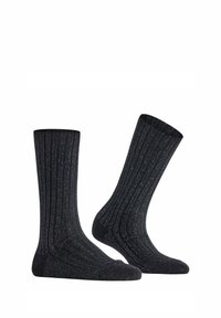 Schwarze gerippte Socken mit einer strukturierten Oberfläche, in regulärer Länge und subtilen silbernen Fäden für einen leichten Glanz.