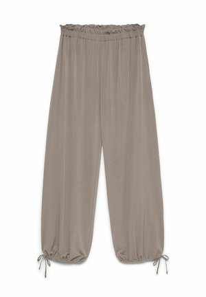 Pantalon taupe ample avec taille élastique et chevilles froncées attachées par de fines lanières en tissu.