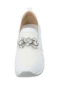White fabric slip-on shoe with textured upper, rubber sole, and a decorative crystal embellishment at the center.