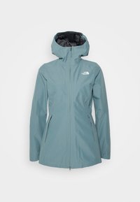 Modrá dámská nepromokavá bunda s kapucí, předním zipem, bočními kapsami a bílým logem The North Face na hrudi.