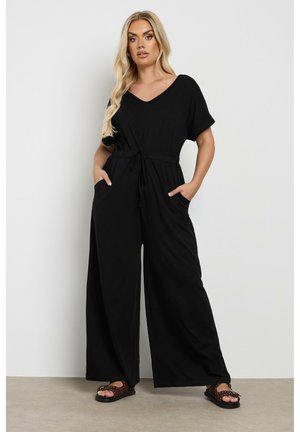 Schwarzer Jumpsuit mit V-Ausschnitt, kurzen Ärmeln, elastischem Kordelzugbund und weitem Bein. Verfügt über Seitentaschen und eine weiche Textur.