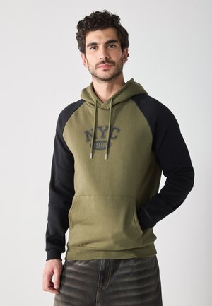 Hooded sweatshirt with olive green body and black raglan sleeves. Features "NYC 1990" graphic, front pocket, and drawstring hood.