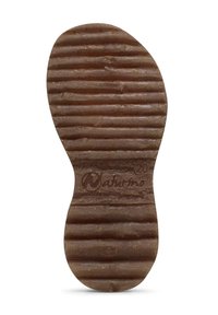 Brun gummiyttersida med texturerade räfflor och rundad form. Har prägling av logotyp och storleksdetaljer för tydlig identifiering.