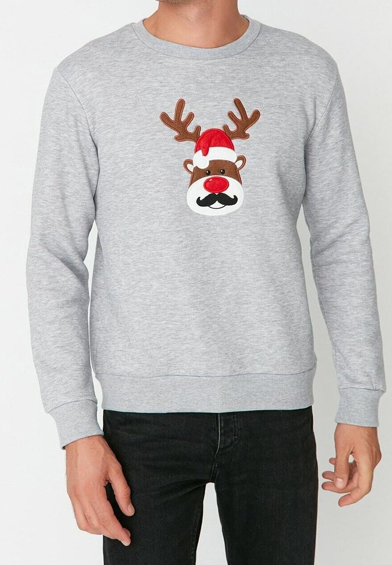 Sudadera gris con la cara de un reno que tiene cuernos, nariz roja, bigote negro y un gorro de Santa rojo, hecha de un tejido suave y texturizado.