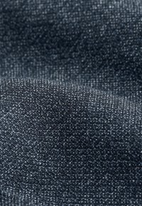 Dark denim fabric with a smooth texture, featuring a subtle twill weave and slight sheen, showcasing intricate stitching details.