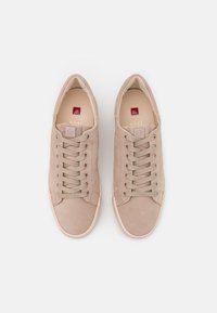 Baskets beiges avec une tige en daim lisse, un bout rond, et une fermeture à lacets à six œillets. Elles disposent d'une semelle plate et d'un marquage minimaliste.
